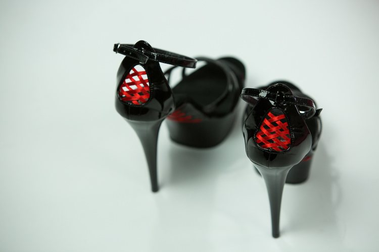 black platform heels with a red corset back