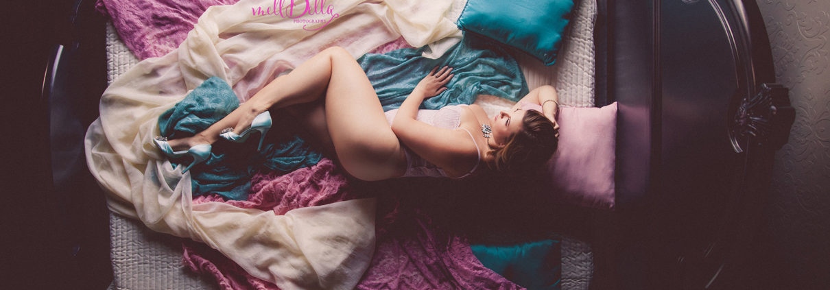 mellbella above the teal, pink, and ivory bed