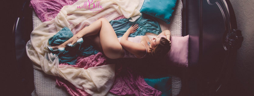 mellbella above the teal, pink, and ivory bed