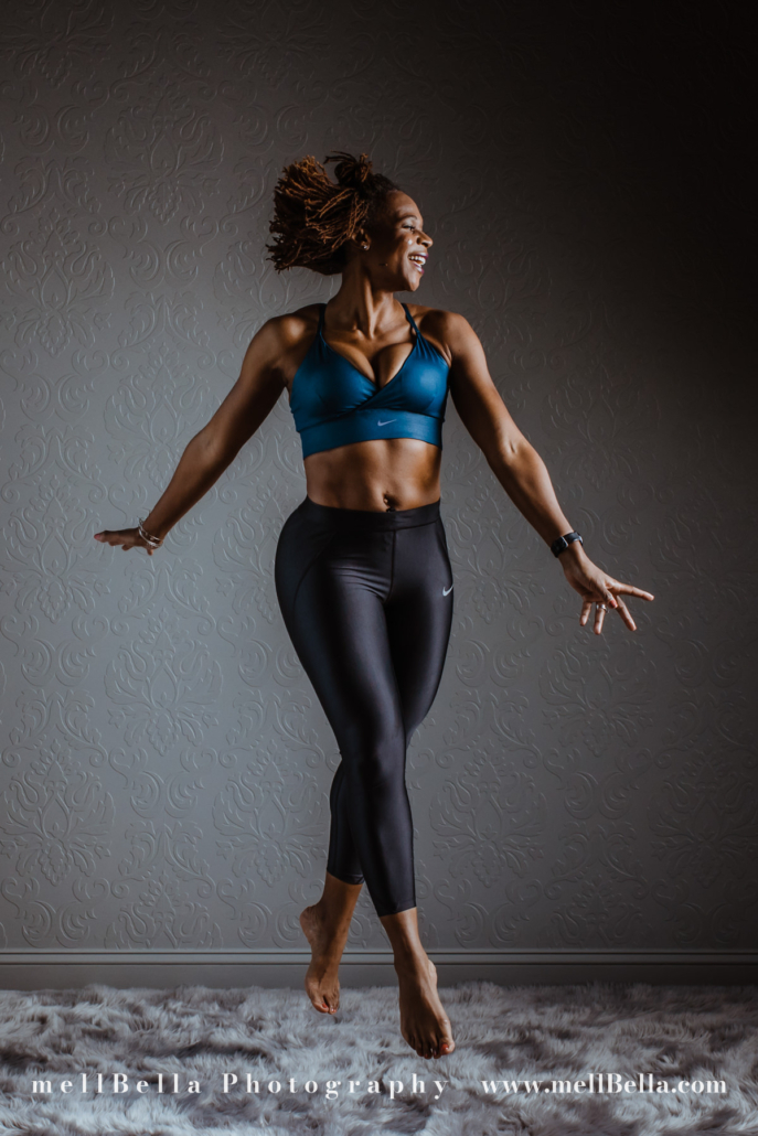 teal sports bra and black capri exercise pants