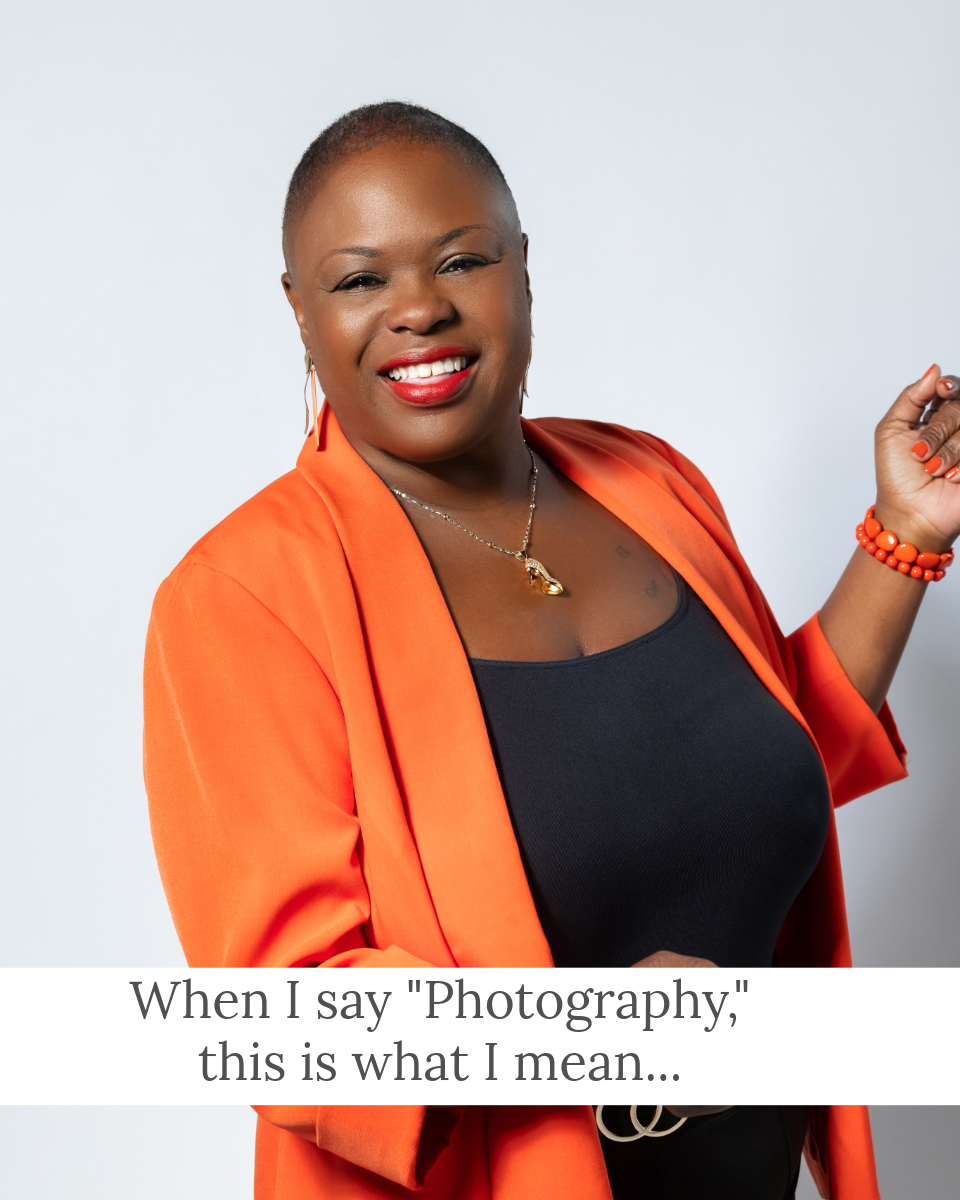 woman in orange suit jacket smiling and dancing