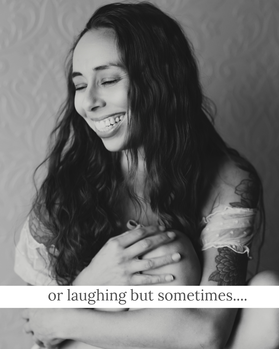 woman hugging her knee and laughing