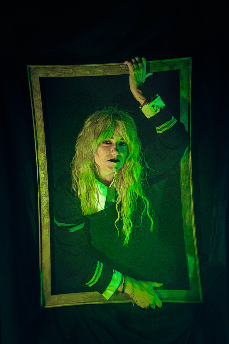 woman coming out of a frame in spooky in green lighting